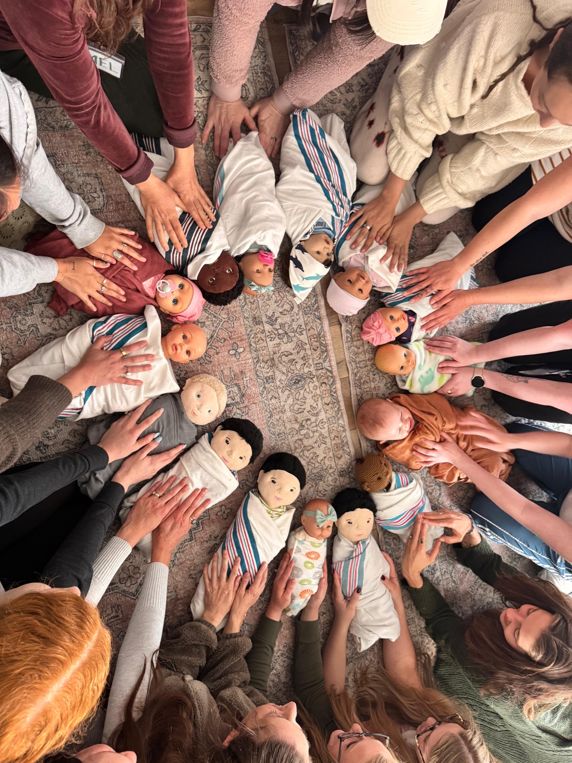 Hands-on newborn care training with a group of doulas